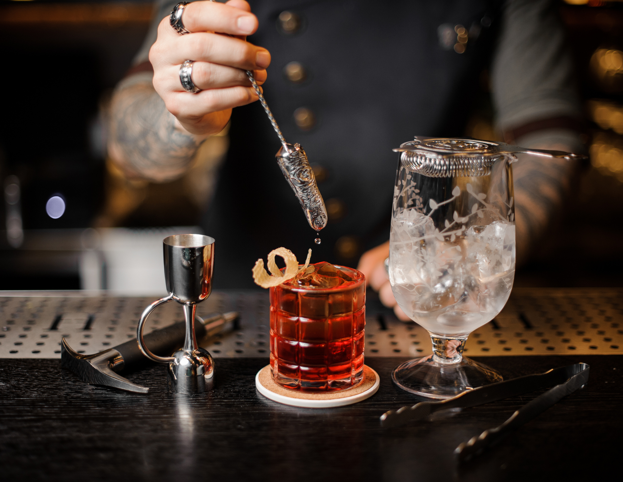 A group raising glasses in a toast, evoking the signature cocktails at Whiskey Business
